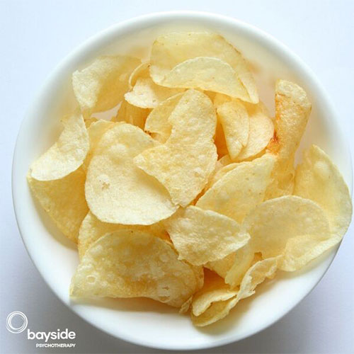 picture with a white bowl of chips on a light gray background and Bayside Psychotherapy logo