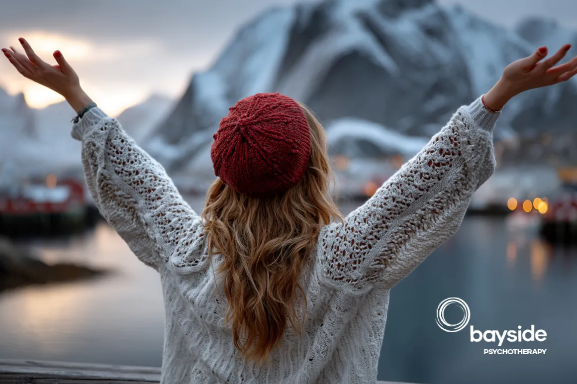 a girl standing in front of the lake in winters season