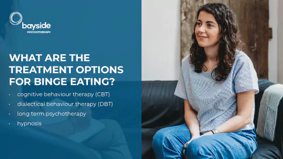 young woman with long wavy hair sitting on a couch and looking very optimistic and text about the binge eating treating options